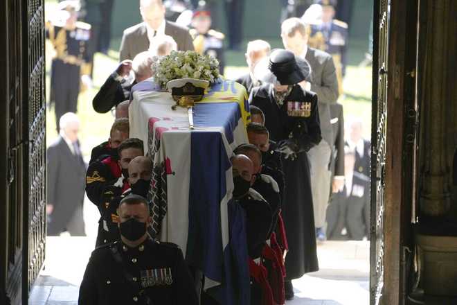 Pallbearers carry the coffin of the Duke of Edinburgh into St George's Chapel for his funeral, at Windsor Castle, in Windsor, England, Saturday April 17, 2021. Prince Philip died April 9 at the age of 99 after 73 years of marriage to Britain's Queen Elizabeth II. (Danny Lawson/Pool via AP)