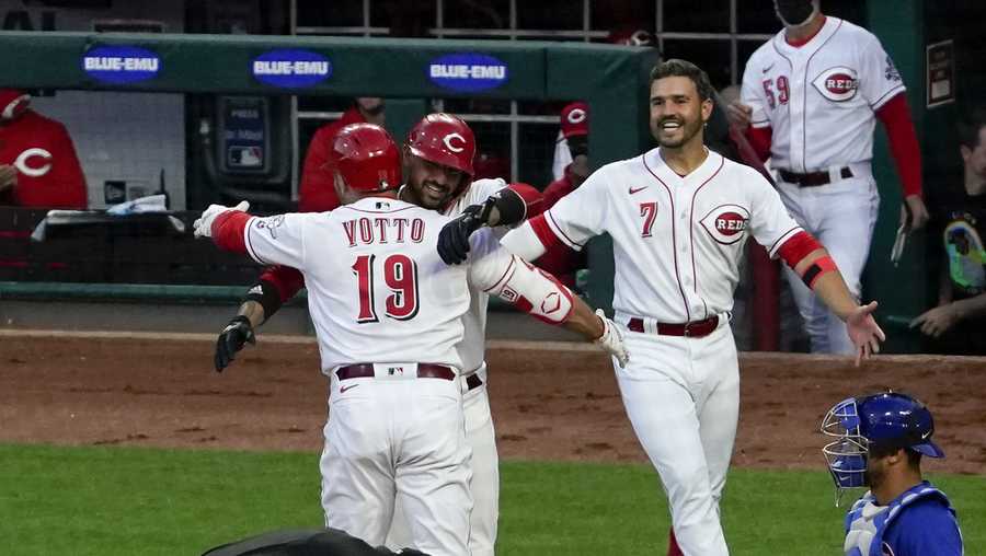 Cincinnati Reds' Joey Votto (19) is congratulated by Nick Castellanos (2) at home plate after hitting a two-run home run, his 300th career home run, in the third inning of a baseball game against the Chicago Cubs at Great American Ball Park in Cincinnati on Friday, April 30, 2021. (AP Photo/Jeff Dean)