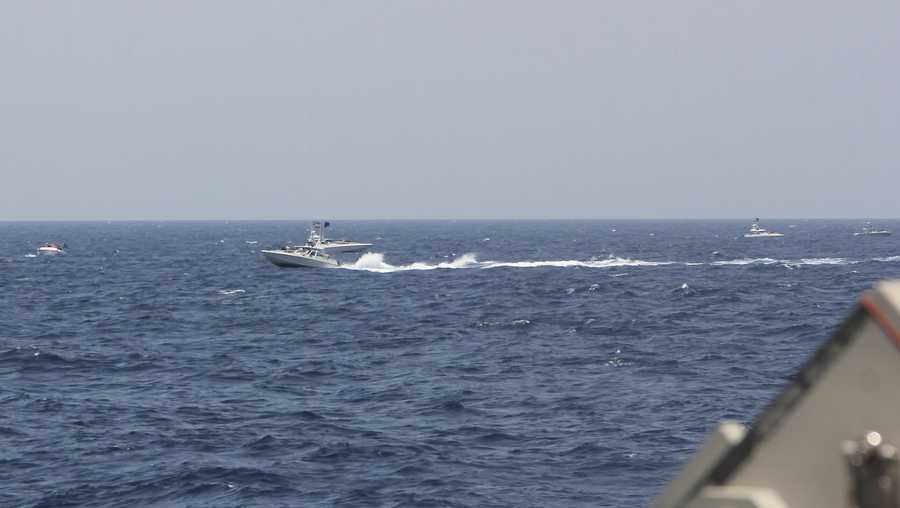 In this image provided by the U.S. Navy, an Iranian Islamic Revolutionary Guard Corps Navy (IRGCN) fast in-shore attack craft (FIAC), a type of speedboat armed with machine guns, speeds near U.S. naval vessels transiting the Strait of Hormuz, Monday, May 10, 2021.