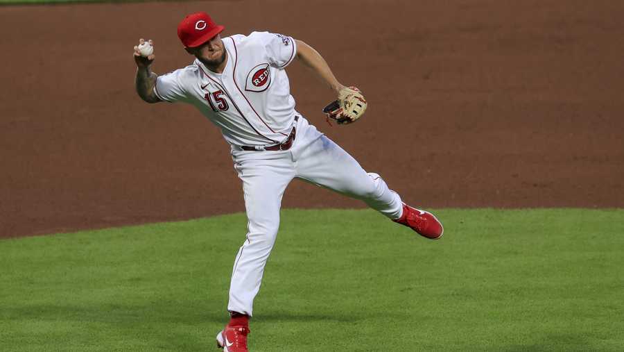 Cincinnati Reds' Nick Senzel fields the ball during a baseball game against the San Francisco Giants in Cincinnati, Monday, May 17, 2021. The Giants won 6-3. (AP Photo/Aaron Doster)