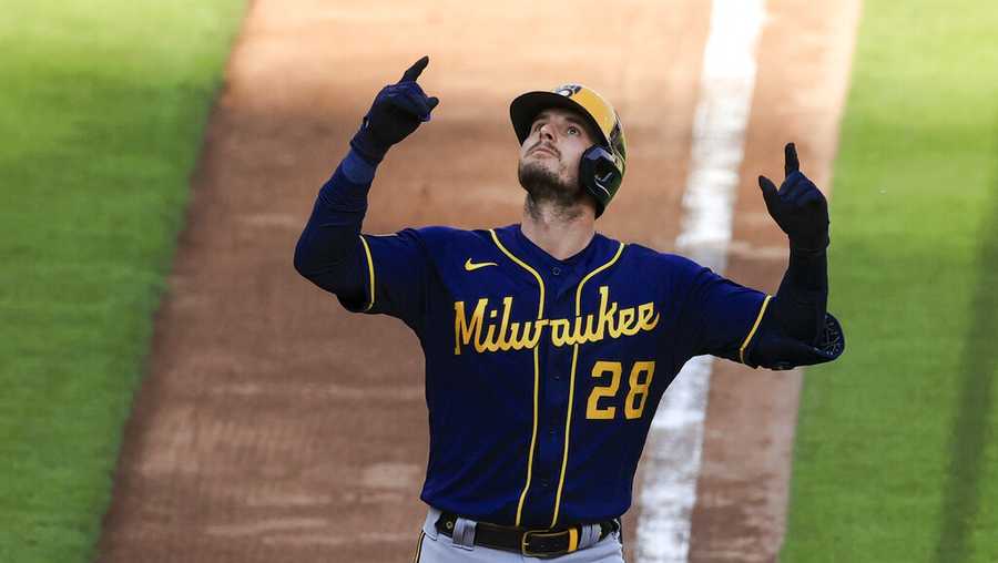 Milwaukee Brewers&apos; Daniel Robertson celebrates hitting a solo home run during the seventh inning of a baseball game against the Cincinnati Reds in Cincinnati, Saturday, May 22, 2021. (AP Photo/Aaron Doster)