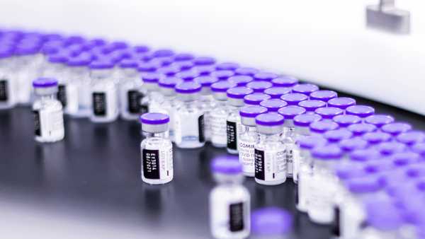 In this March 2021 photo provided by Pfizer, vials of the Pfizer-BioNTech COVID-19 vaccine are prepared for packaging at the company's facility in Puurs, Belgium. Pfizer is about to seek U.S. authorization for a third dose of its COVID-19 vaccine, saying Thursday, July 8, 2021, that another shot within 12 months could dramatically boost immunity and maybe help ward off the latest worrisome coronavirus mutant. (Pfizer via AP)