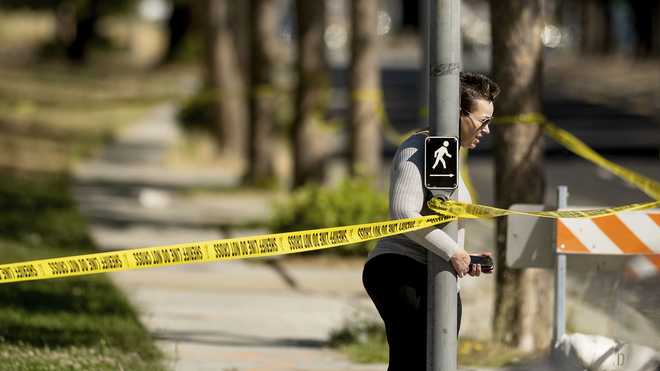 A&#x20;woman&#x20;leaves&#x20;the&#x20;scene&#x20;of&#x20;a&#x20;shooting&#x20;at&#x20;a&#x20;Santa&#x20;Clara&#x20;Valley&#x20;Transportation&#x20;Authority&#x20;&#x28;VTA&#x29;&#x20;facility&#x20;on&#x20;Wednesday,&#x20;May&#x20;26,&#x20;2021,&#x20;in&#x20;San&#x20;Jose,&#x20;Calif.&#x20;Santa&#x20;Clara&#x20;County&#x20;sheriff&#x27;s&#x20;spokesman&#x20;said&#x20;the&#x20;rail&#x20;yard&#x20;shooting&#x20;left&#x20;multiple&#x20;people,&#x20;including&#x20;the&#x20;shooter,&#x20;dead.