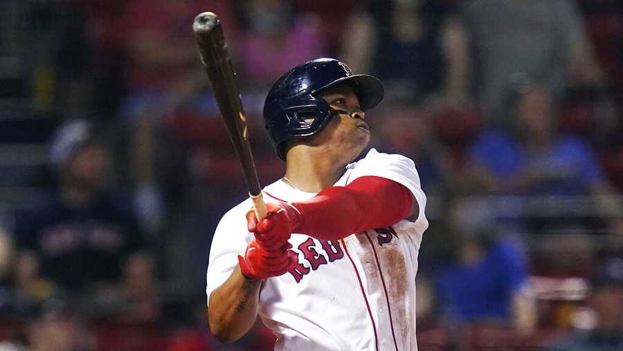 Boston Red Sox's Rafael Devers watches his two-run home run during the fourth inning of the team's baseball game against the Atlanta Braves at Fenway Park, Wednesday, May 26, 2021, in Boston. (AP Photo/Charles Krupa)