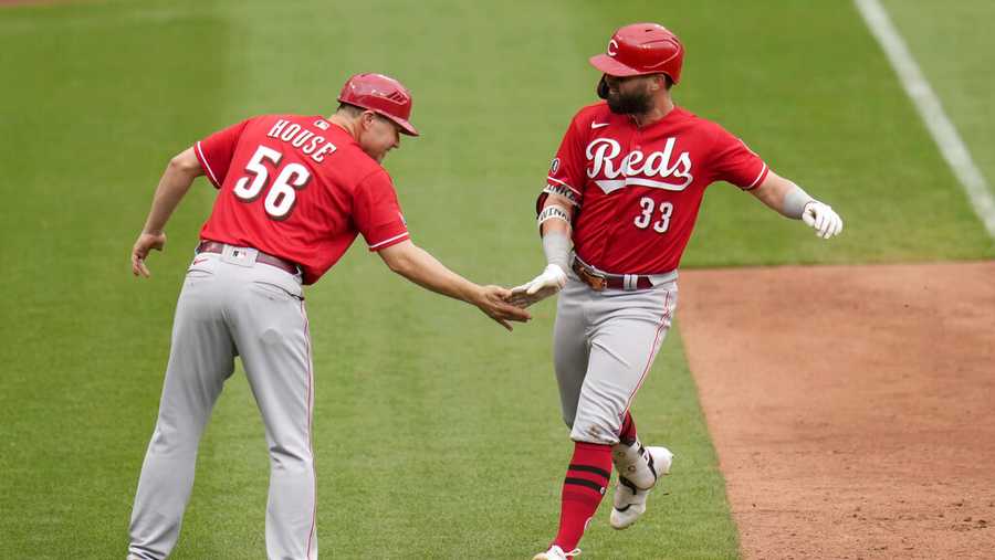 Cincinnati Reds&apos; Jesse Winker (33) is congratulated by third base coach J.R. House after hitting a solo home run during the ninth inning of a baseball game against the St. Louis Cardinals Sunday, June 6, 2021, in St. Louis. (AP Photo/Jeff Roberson)