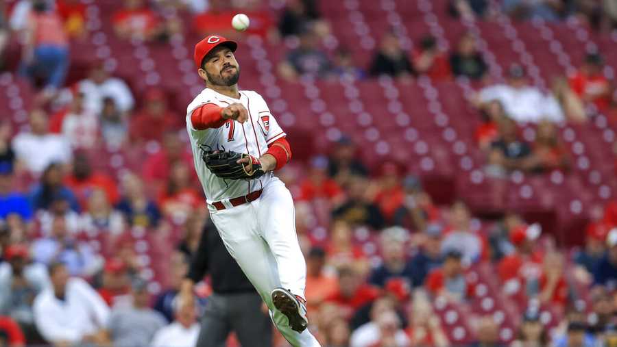 Cincinnati Reds&apos; Eugenio Suarez throws to first base for the out on a sacrifice bunt by Milwaukee Brewers&apos; Travis Shaw during the fourth inning of a baseball game against the Milwaukee Brewers in Cincinnati, Tuesday, June 8, 2021. (AP Photo/Aaron Doster)