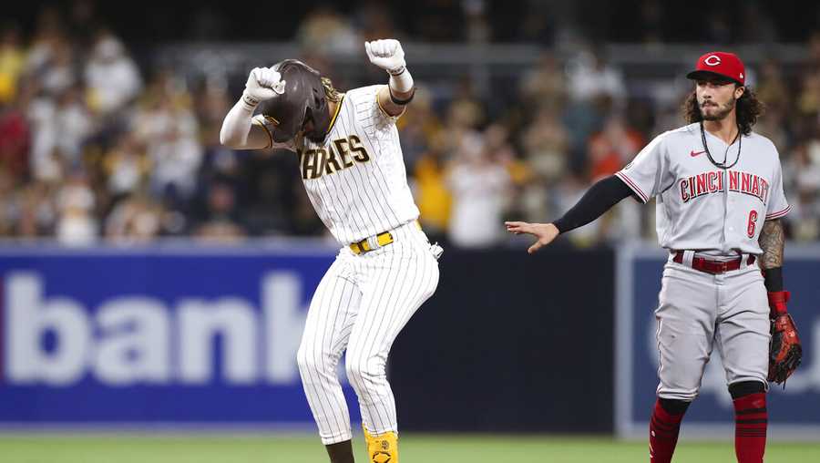 San Diego Padres&apos; Fernando Tatis Jr., left, dances at second base in front of Cincinnati Reds&apos; Jonathan India (6) after hitting a double during the third inning of a baseball game Friday, June 18, 2021, in San Diego. (AP Photo/Derrick Tuskan)