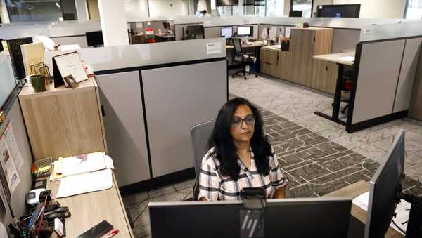 Shobha Surya, associate manager for projects and sales operations of Ajinomoto, a global food and pharmaceutical company, works in a shared office space in Itasca, Ill., Monday, June 7, 2021. Surya said she feels energized by the light pouring in from skylights at the new headquarters, adding that she missed her colleagues and is thrilled to be back in-person. (AP Photo/Shafkat Anowar)