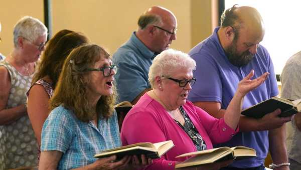 Members of Waldoboro United Methodist Church sing a hymn, Sunday, June 20, 2021, in Waldoboro, Maine. The combination of a dwindling church population and COVID-19 reduced attendance to the point that a decision was made to close the 164-year-old church. (AP Photo/Robert F. Bukaty)