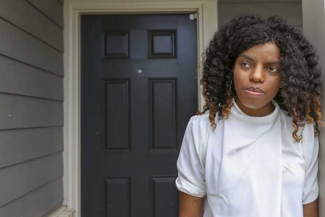 Crystal Marie McDaniels stands in front of her Charlotte, N.C. home on Friday, July 9, 2021.
