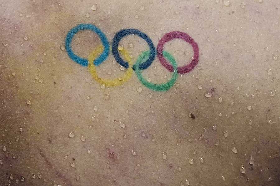 Water droplets fall down the back over a Olympics rings tattoo of Townley Haas, of the United States, swims at the 2020 Summer Olympics, Sunday, July 25, 2021, in Tokyo, Japan. (AP Photo/Charlie Riedel) Water droplets fall down the back over a Olympics rings tattoo of Townley Haas, of the United States, swims at the 2020 Summer Olympics, Sunday, July 25, 2021, in Tokyo, Japan. (AP Photo/Charlie Riedel)