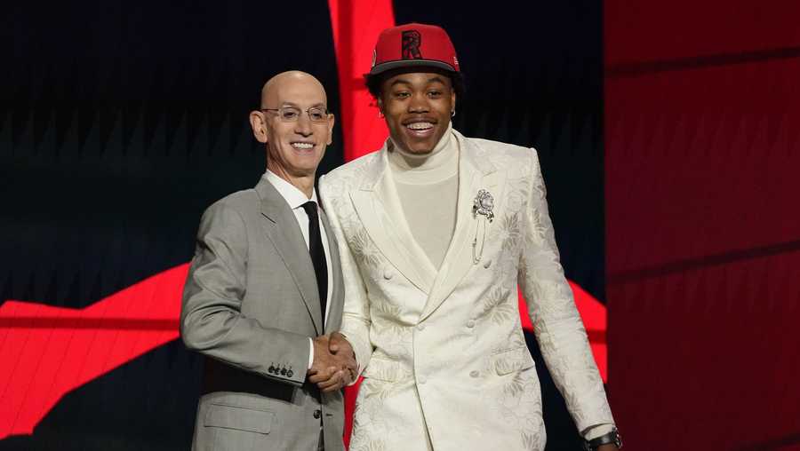 Scottie Barnes, right, poses for a photo with NBA Commissioner Adam Silver after being selected fourth overall by the Toronto Raptors during the first round of the NBA basketball draft, Thursday, July 29, 2021, in New York. (AP Photo/Corey Sipkin)