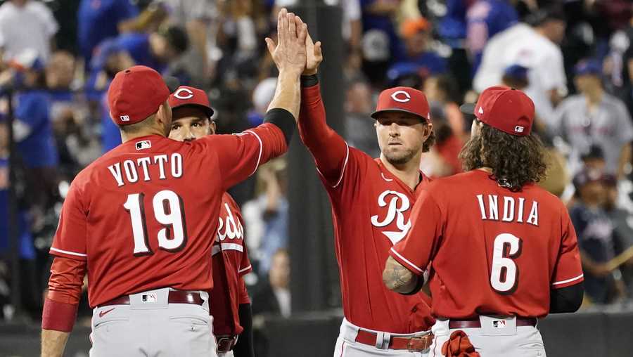Cincinnati Reds' Joey Votto (19), Eugenio Suarez, second from left, Kyle Farmer, second from right, and Jonathan India (6) celebrate after defeating the New York Mets in a baseball game, Friday, July 30, 2021, in New York. (AP Photo/Mary Altaffer)