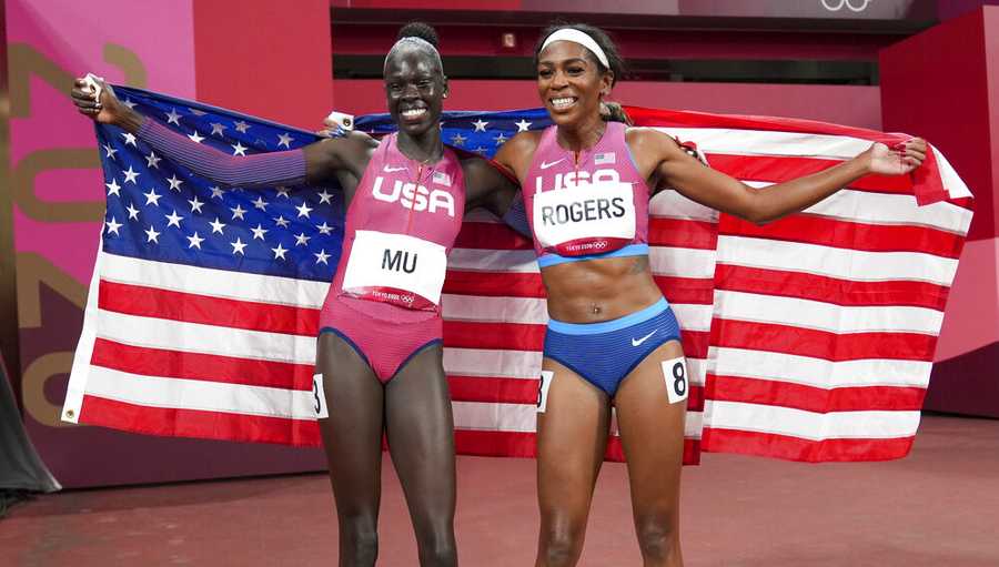 Athing Mu, of the United States, celebrates after winning the gold medal in the women's 800-meter final, with bronze medalist Raevyn Rogers, right, also of the United States, at the 2020 Summer Olympics, Tuesday, Aug. 3, 2021, in Tokyo. (AP Photo/Matthias Schrader)