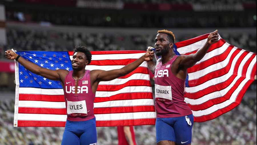 Kenneth Bednarek, of United States, silver, and Noah Lyles, of United States, bronze, react after the final of the men's 200-meters at the 2020 Summer Olympics, Wednesday, Aug. 4, 2021, in Tokyo, Japan. (AP Photo/Francisco Seco)
