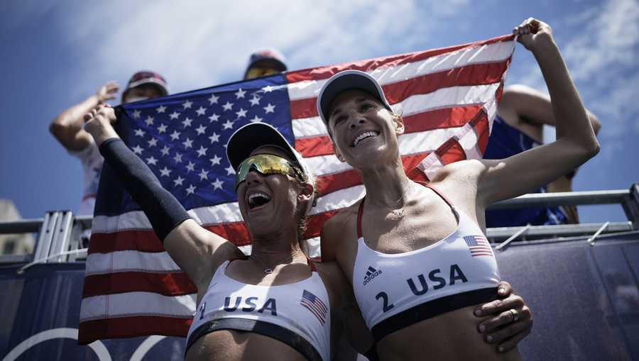 April Ross, left, of the United States, and teammate Alix Klineman celebrate winning a women's beach volleyball Gold Medal match against Australia at the 2020 Summer Olympics, Friday, Aug. 6, 2021, in Tokyo, Japan. (AP Photo/Felipe Dana)