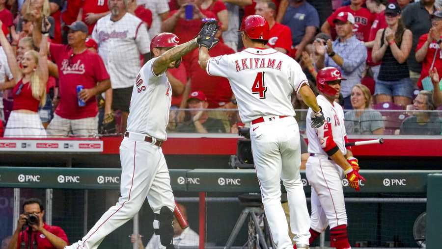 Cincinnati Reds&apos; Shogo Akiyama (4) celebrates with Nick Castellanos after scoring on a double by Jesse Winker during the third inning of the team&apos;s baseball game against the Pittsburgh Pirates in Cincinnati on Saturday, Aug. 7, 2021. (AP Photo/Jeff Dean)