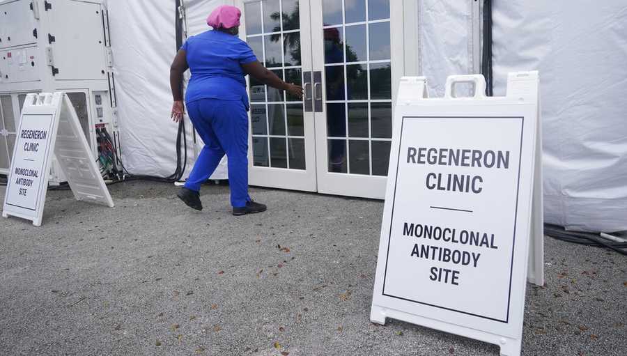FILE: A nurse enters a monoclonal antibody site, Wednesday, Aug. 18, 2021, at C.B. Smith Park in Pembroke Pines. Numerous sites are open around the state offering monoclonal antibody treatment sold by Regeneron to people who have tested positive for COVID-19. (AP Photo/Marta Lavandier)