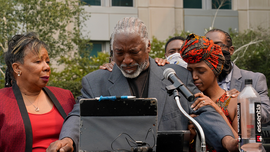 Joe Powell is comforted by his daughter, Nakia Porter, right, during a news conference to announce the filing of a federal lawsuit that has brought against two Solano County Sheriff's deputies, Wednesday, Aug. 18, 2021, in Sacramento, Calif. The lawsuit stems from an incident where the pair, and Porters's three daughters, had pulled over on the side of the road in Dixon on Aug. 6, 2020, so Powell could take over the driving from his daughter. As they were stopped the two deputies squad car pulled up behind and confronted Porter and her father and eventually knocked Porter unconscious and arrested her, then later lied about the incident. The suit accuses the deputies of violating state federal civil rights statutes by engaging in "unlawful seizure, assault and excessive force."