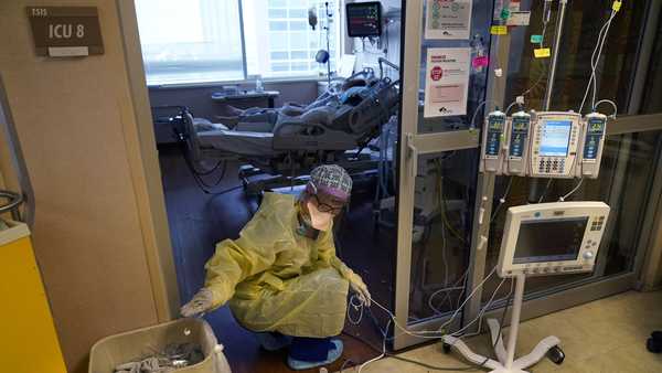 Jodie Ford, an ICU nurse, moves electrical cords for medical machines, outside the room of a patient suffering from COVID-19, in an intensive care unit at the Willis-Knighton Medical Center in Shreveport, La., Tuesday, Aug. 17, 2021. (AP Photo/Gerald Herbert)