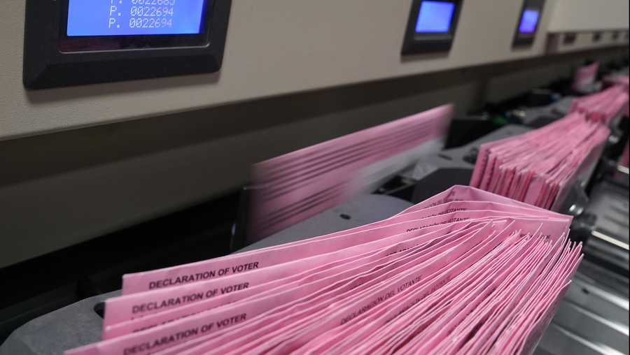 FILE— In this Aug. 30, 2021, file photo mail in ballots run through a sorting machine at the Sacramento County Registrar of Voters office in Sacramento, Calif. On Thursday, Sept. 2, the state Senate approved a bill that would require county election offices to automatically mail a ballot to all active registered voters at least 29 days before an election even if they didn&apos;t ask for one. The bill, AB37 by Democratic Assemblyman Marc Berman was approved and sent to the Assembly for a final vote. (AP Photo/Rich Pedroncelli, File)