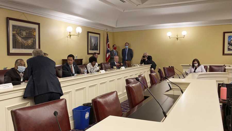 Republican Ohio Gov. Mike DeWine, foreground, speaks to state Sen. Vernon Sykes, seated, the co-chair of the Ohio Redistricting Commission, as other members of the panel prepared for a meeting on Wednesday, Sept. 15, 2021, at the Ohio Statehouse in Columbus, Ohio. (AP Photo/Julie Carr Smyth)