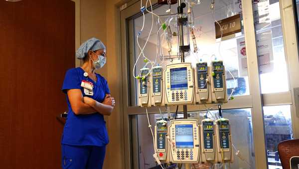 FILE - In this Aug. 17, 2021, file photo, nursing coordinator Beth Springer looks into a patient's room in a COVID-19 ward at the Willis-Knighton Medical Center in Shreveport, La. COVID-19 deaths in the U.S. have climbed to an average of more than 1,900 a day for the first time since early March, with experts saying the virus is preying largely on a select group: 71 million unvaccinated Americans. (AP Photo/Gerald Herbert, File)