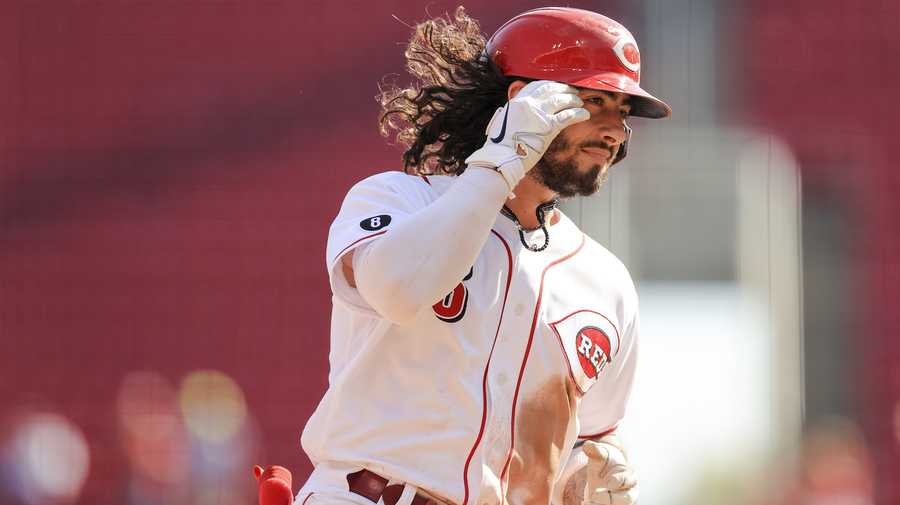 Cincinnati Reds' Jonathan India fixes his hair as he runs the bases after hitting a two-run home run during the seventh inning of a baseball game against the Pittsburgh Pirates in Cincinnati, Monday, Sept. 27, 2021. (AP Photo/Aaron Doster)