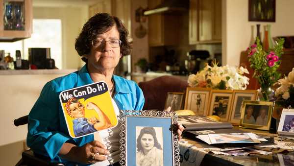 Dorene Giacopini holds up a photo of her mother Primetta Giacopini while posing for a photo at her home in Richmond, Calif. on Monday, Sept 27, 2021. Primetta Giacopini's life ended the way it began — in a pandemic. She was two years old when she lost her mother to the Spanish flu in Connecticut in 1918. Giacopini contracted COVID-19 earlier this month. The 105-year-old struggled with the disease for a week before she died Sept. 16. (AP Photo/Josh Edelson)