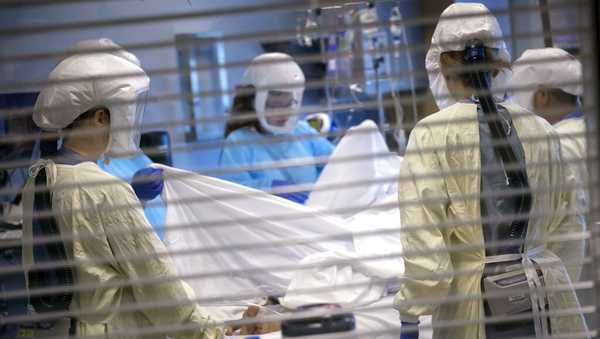 In this image provided by the University of Utah Health, medical professionals look after a COVID-19 patient in the intensive care unit on July 30, 2021, in Salt Lake City. (Charlie Ehlert/University of Utah Health via AP)