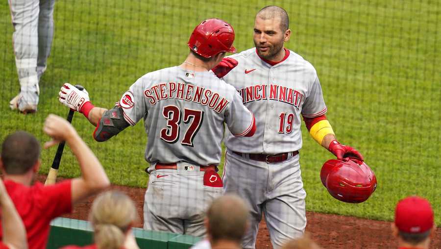 Cincinnati Reds&apos; Joey Votto (19) celebrates with Tyler Stephenson as he returns to the dugout after hitting a three-run home run off Pittsburgh Pirates starting pitcher Cody Ponce (44) during the fifth inning of a baseball game in Pittsburgh, Sunday, Oct. 3, 2021. (AP Photo/Gene J. Puskar)