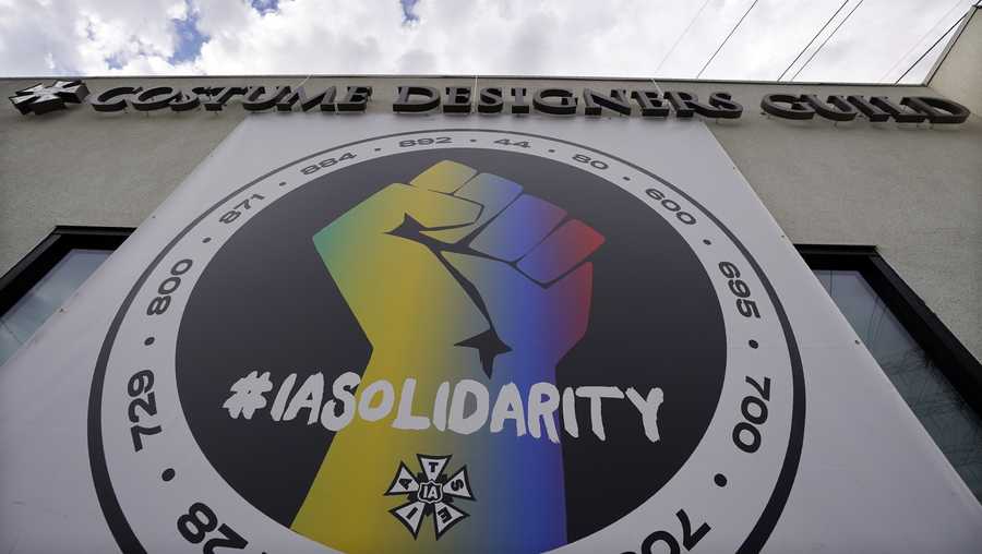 A poster advocating union solidarity hangs from a Costume Designers Guild office building, Monday, Oct. 4, 2021, in Burbank, Calif. The International Alliance of Theatrical Stage Employees (IATSE) overwhelmingly voted to authorize a strike for the first time in its 128-year history.