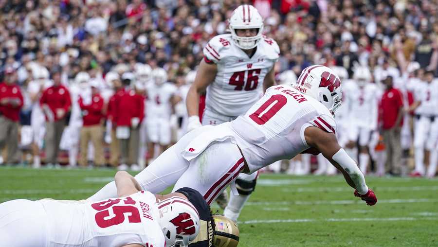 Wisconsin running back Braelon Allen (0) dives in for a touchdown over Purdue linebacker Kieren Douglas (43) during the first half of an NCAA college football game in West Lafayette, Ind., Saturday, Oct. 23, 2021. (AP Photo/Michael Conroy)