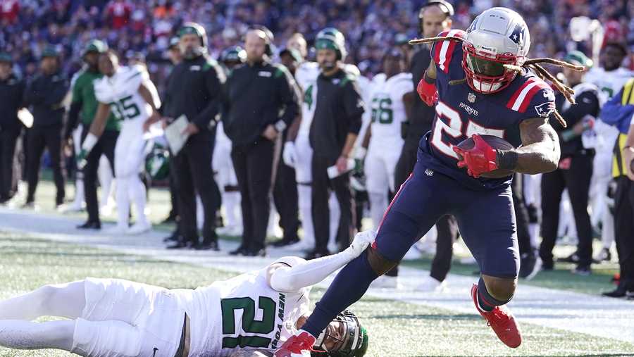 New England Patriots running back Brandon Bolden (25) tries to break free from New York Jets safety Ashtyn Davis (21) during the first half of an NFL football game, Sunday, Oct. 24, 2021, in Foxborough, Mass. (AP Photo/Steven Senne)