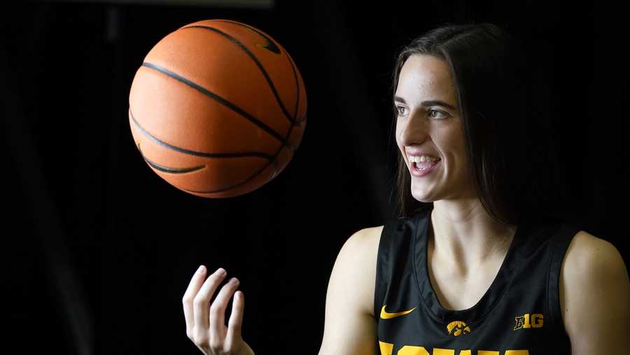 Iowa guard Caitlin Clark poses for photographers during Iowa&apos;s NCAA college basketball media day, Thursday, Oct. 28, 2021, in Iowa City, Iowa. Last season Clark put up the best numbers in the country as a freshman, was a consensus All-American and led Iowa deep into the NCAA tournament. Asked what she could do for an encore for the ninth-ranked Hawkeyes, Clark smiled and said, "I think just come back and be myself again." (AP Photo/Charlie Neibergall)