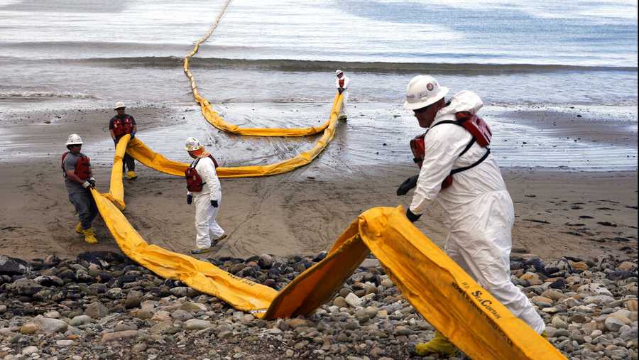 FILE - In this May 21, 2015, file photo, workers prepare an oil containment boom at Refugio State Beach, north of Goleta, Calif., two days after an oil pipeline ruptured, polluting beaches and killing hundreds of birds and marine mammals. A proposal to replace a pipeline near Santa Barbara that was shut down in 2015 after causing California&apos;s worst coastal oil spill in 25 years is inching through a government review, even as the state moves toward banning gas-powered vehicles and oil drilling. (AP Photo/Jae C. Hong, File)