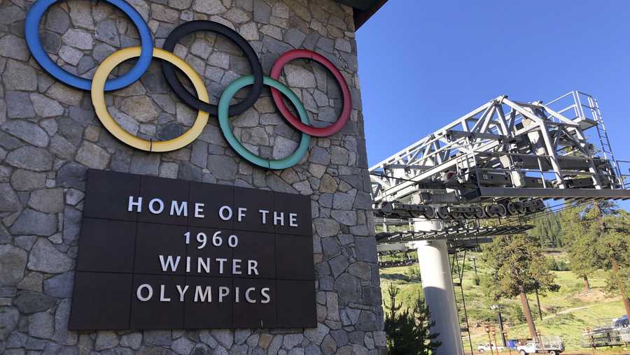 FILE - A sign marking the 1960 Winter Olympics is seen by a chairlift at what was then called Squaw Valley Ski Resort, July 9, 2020, in Olympic Valley, Calif. A new documentary produced by a former Sierra Nevada University student gives a voice to the women of the Washoe Tribe to explain why the word "squaw" is so offensive to them and why they&apos;re so pleased that the Lake Tahoe ski resort that carried the name for more than a half century now has a new one. It announced in August 2020 it was launching an effort to find a new name and sought input from the local tribe during a yearlong planning process before formally switching to Palisades Tahoe in September of this year. (AP Photo/Haven Daley, File)