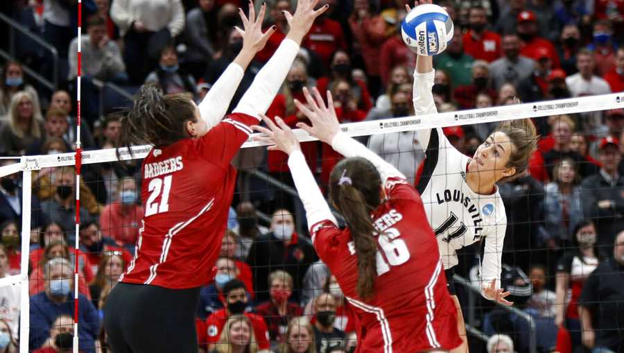 Louisville&apos;s Anna Stevenson, right, spikes the ball in front of Wisconsin&apos;s Grace Loberg left, and Dana Rettke during a semifinal match in the NCAA women&apos;s college volleyball tournament, Thursday, Dec. 16, 2021, in Columbus, Ohio. (AP Photo/Paul Vernon)