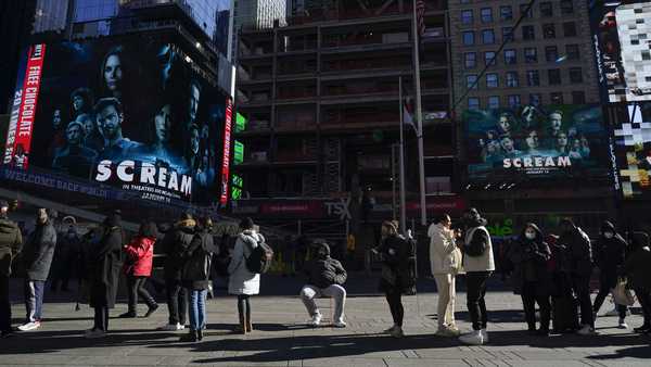 People wait in a long line to get tested for COVID-19 in Times Square, New York, Monday, Dec. 20, 2021.