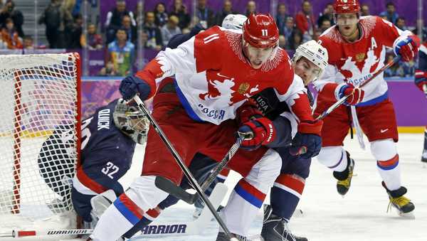 FILE -Russia forward Yevgeni Malkin seals off the puck from USA defenseman Ryan McDonagh in the first period of a men's ice hockey game at the 2014 Winter Olympics, Saturday, Feb. 15, 2014, in Sochi, Russia. NHL players will not take part in the upcoming Winter Olympics in Beijing after all. A person with direct knowledge of the decision tells The Associated Press the league is going to withdraw from the Olympics after the regular-season schedule was disrupted by coronavirus outbreaks, Tuesday, Dec. 21, 2021.