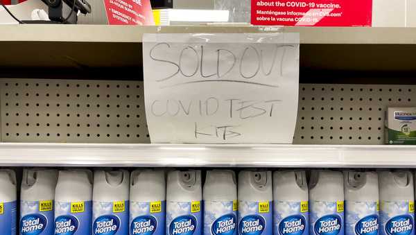 A handwritten notice is posted on an empty shelf after at-home COVID-19 test kits were sold out at a CVS store in La Habra, Calif., Tuesday, Dec. 28, 2021. (AP Photo/Jae C. Hong)