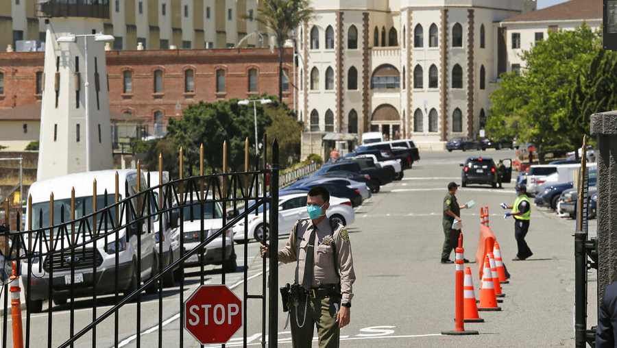 FILE - In this July 9, 2020, file photo, a correctional officer closes the main gate at San Quentin State Prison in San Quentin, Calif. A judge on Wednesday, Dec. 29, 2021, temporarily halted California&apos;s plans to speed the potential prison release dates for repeat offenders with serious and violent criminal histories under the state&apos;s "three strikes" law. (AP Photo/Eric Risberg, File)