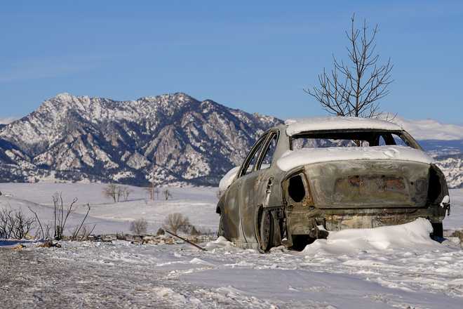 Snow&#x20;covers&#x20;the&#x20;burned&#x20;remains&#x20;of&#x20;a&#x20;car&#x20;after&#x20;wildfires&#x20;ravaged&#x20;the&#x20;area&#x20;Sunday,&#x20;Jan.&#x20;2,&#x20;2022,&#x20;in&#x20;Superior,&#x20;Colo.&#x20;&#x20;Investigators&#x20;are&#x20;still&#x20;trying&#x20;to&#x20;determine&#x20;what&#x20;sparked&#x20;a&#x20;massive&#x20;fire&#x20;in&#x20;a&#x20;suburban&#x20;area&#x20;near&#x20;Denver&#x20;that&#x20;burned&#x20;neighborhoods&#x20;to&#x20;the&#x20;ground&#x20;and&#x20;destroyed&#x20;nearly&#x20;1,000&#x20;homes&#x20;and&#x20;other&#x20;buildings.&#x20;&#x20;&#x28;AP&#x20;Photo&#x2F;Jack&#x20;Dempsey&#x29;