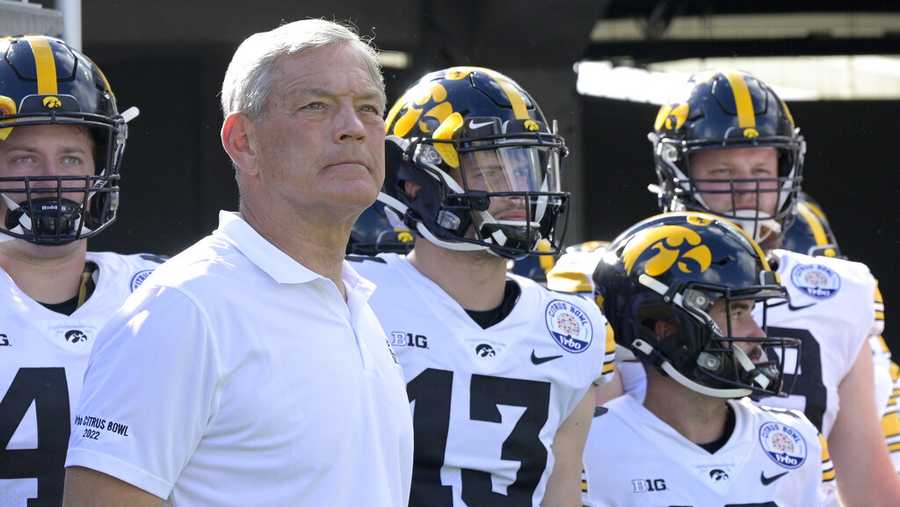 Iowa head coach Kirk Ferentz, front left, waits to take the field with his players before the Citrus Bowl NCAA college football game against Kentucky, Saturday, Jan. 1, 2022, in Orlando, Fla. (AP Photo/Phelan M. Ebenhack)
