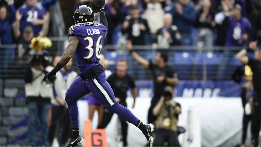 Baltimore Ravens safety Chuck Clark runs in for a touchdown after making an interception off Los Angeles Rams quarterback Matthew Stafford during the first half of an NFL football game, Sunday, Jan. 2, 2022, in Baltimore. (AP Photo/Gail Burton)