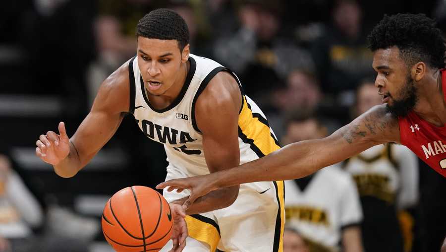 Iowa forward Keegan Murray fights for a loose ball with Maryland forward Donta Scott, right, during the second half of an NCAA college basketball game, Monday, Jan. 3, 2022, in Iowa City, Iowa. (AP Photo/Charlie Neibergall)
