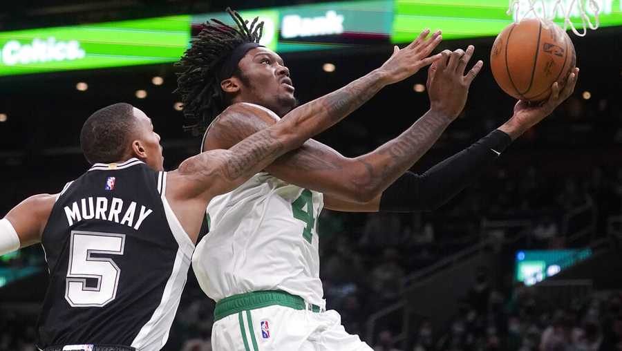 Boston Celtics center Robert Williams III drives to the basket past San Antonio Spurs guard Dejounte Murray (5) during the first half of an NBA basketball game, Wednesday, Jan. 5, 2022, in Boston. (AP Photo/Charles Krupa)