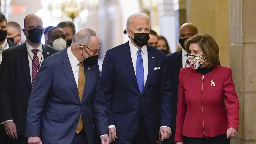 President Joe Biden is flanked by Senate Majority Leader Chuck Schumer of N.Y., left, and House Speaker Nancy Pelosi of Calif., right, after arriving on Capitol Hill in Washington, Thursday, Jan. 6, 2022.
