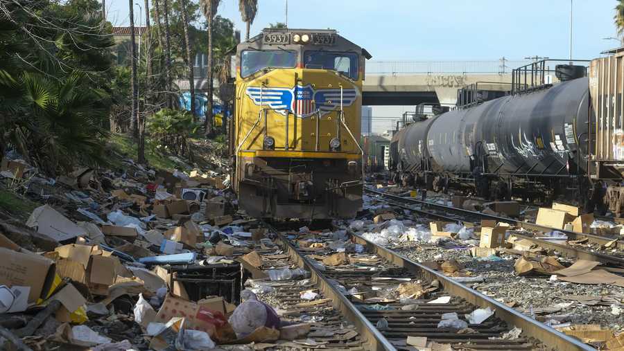 Shredded boxes and packages are seen at a section of the Union Pacific train tracks in downtown Los Angeles Friday, Jan. 14, 2022.  Thieves have been raiding cargo containers aboard trains nearing downtown Los Angeles for months, leaving the tracks blanketed with discarded packages. The sea of debris left behind included items that the thieves apparently didn&apos;t think were valuable enough to take, CBSLA reported Thursday. (AP Photo/Ringo H.W. Chiu)