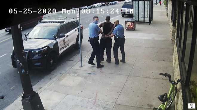 This&#x20;image&#x20;from&#x20;video&#x20;shows&#x20;Minneapolis&#x20;police&#x20;Officers&#x20;Thomas&#x20;Lane,&#x20;left&#x20;and&#x20;J.&#x20;Alexander&#x20;Kueng,&#x20;right,&#x20;escorting&#x20;George&#x20;Floyd,&#x20;center,&#x20;to&#x20;a&#x20;police&#x20;vehicle&#x20;outside&#x20;Cup&#x20;Foods&#x20;in&#x20;Minneapolis,&#x20;on&#x20;May&#x20;25,&#x20;2020.